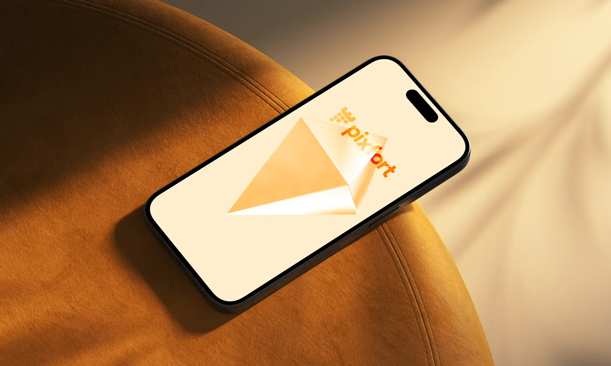 Smartphone resting on an orange suede surface displaying the pixport logo with an orange envelope on a pale background